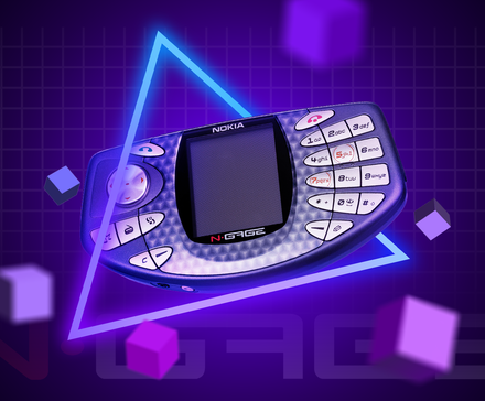 An N-Gage on a purple gradient background with a neon triangle around it and some cubes surrounding it.
