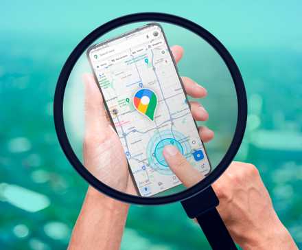 Why A Smartphone Is My Must Have Camping Companion 7 A magnifying glass showing a smartphone with Google Maps open and a person's finger pointing towards the screen.